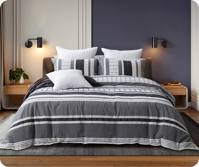 Our striped Dash Duvet Cover shown on a bed with coordinating white accessories.