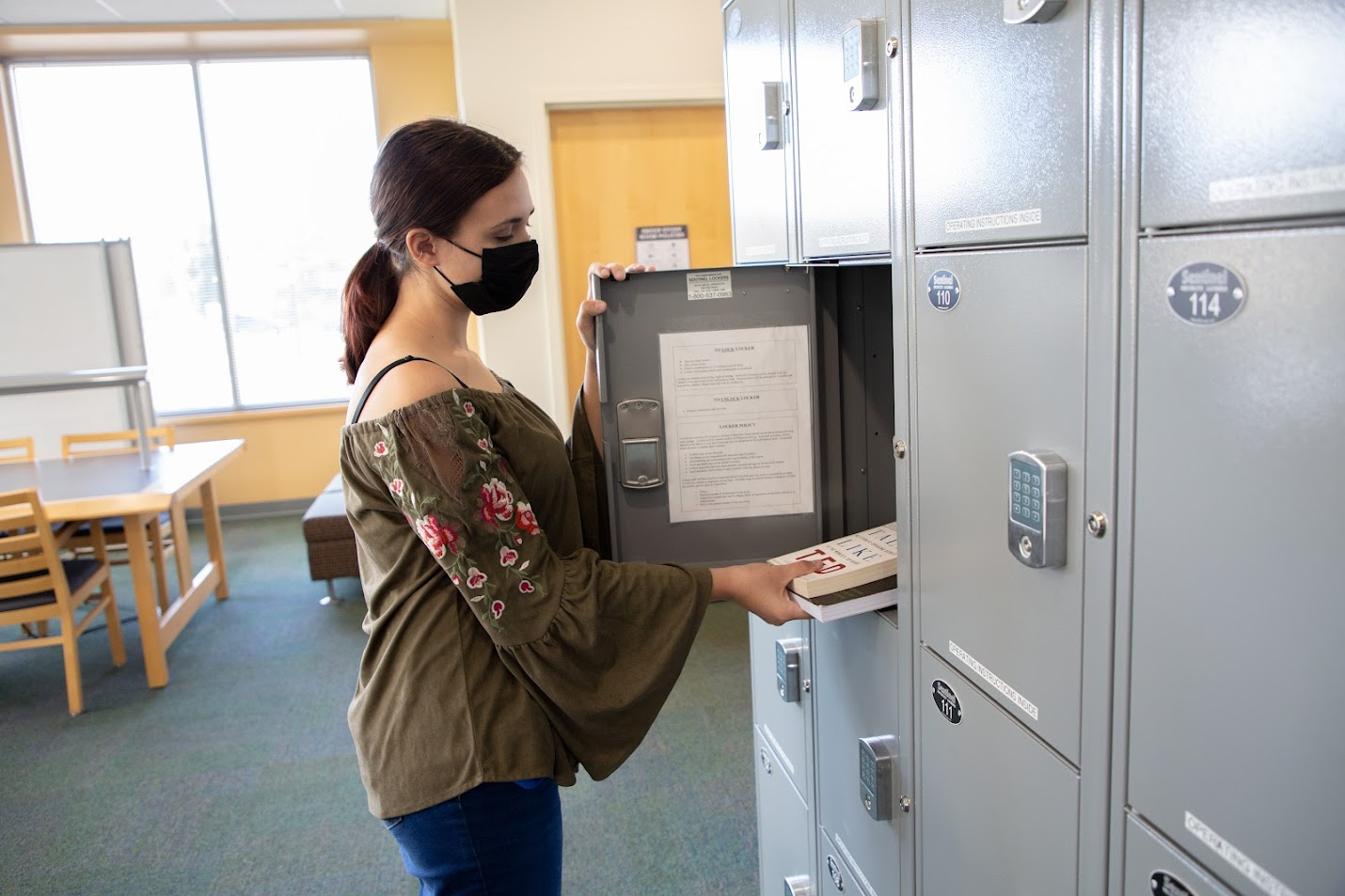 photo of student placing books in a locker that is approximately one cubic foot in size
