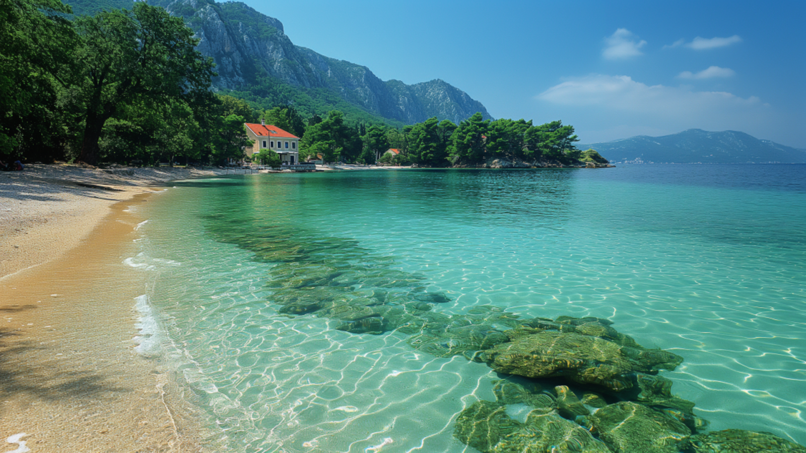 Secluded beach with crystal-clear waters and lush greenery in Croatia.