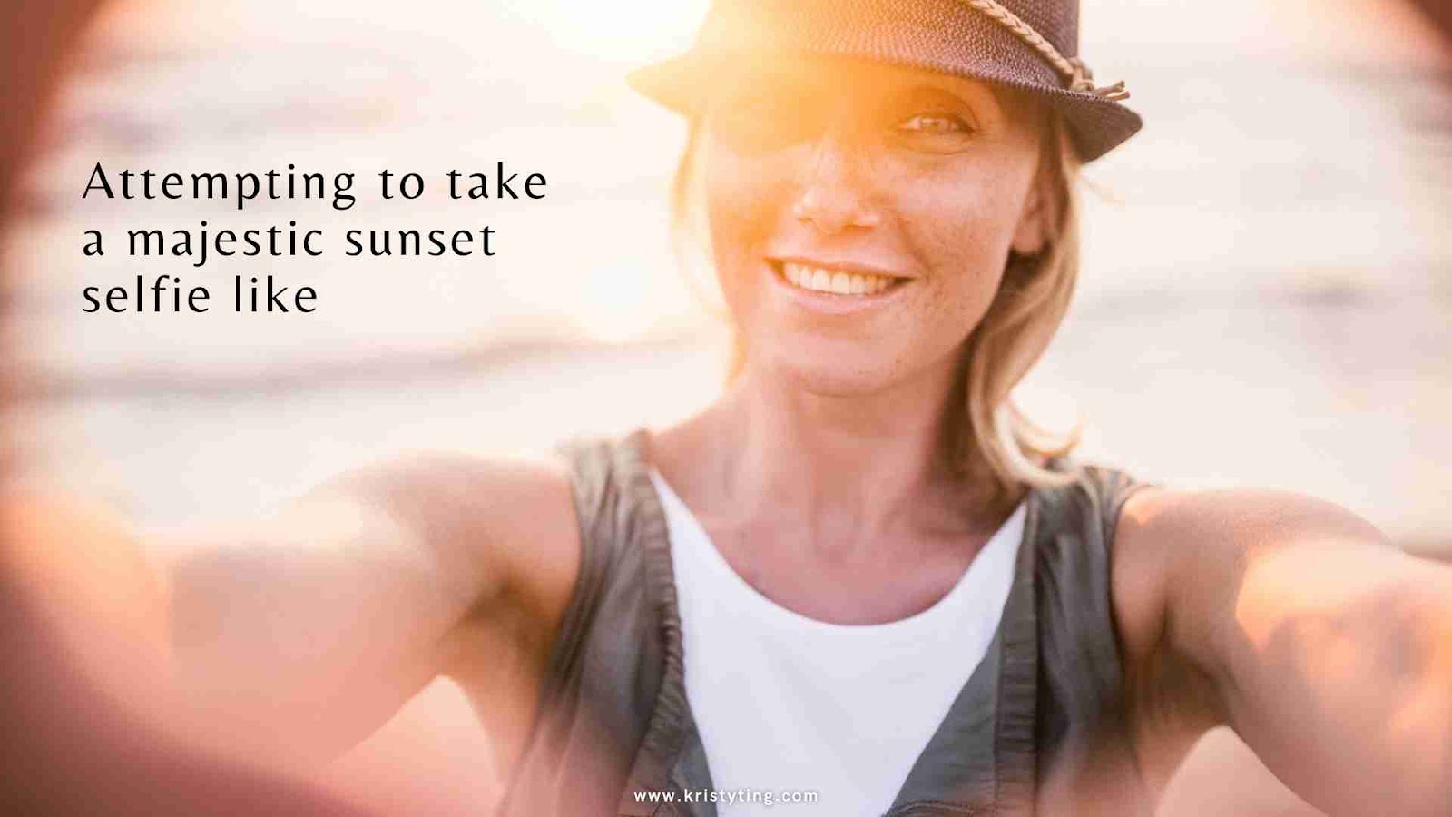 Person smiling for a selfie with the warm glow of a sunset in the background.