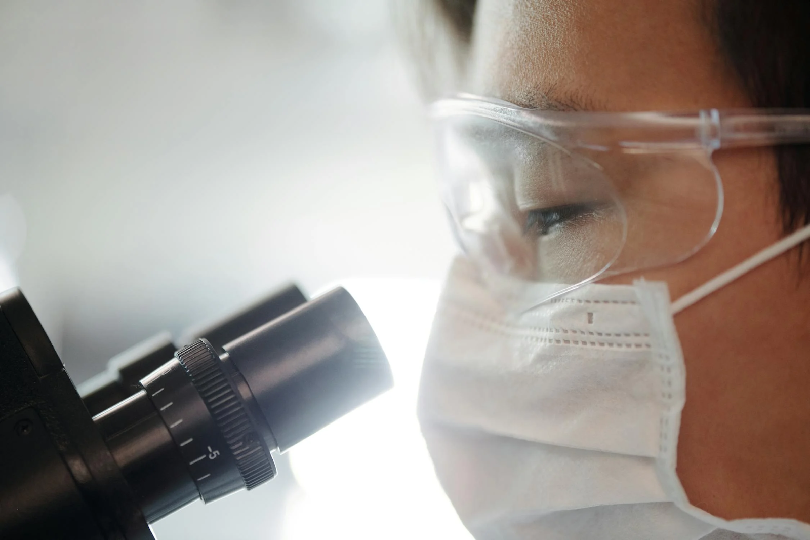 Doctor looks through a microscope