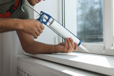 how to insulate your windows in cold weather contractor applying caulking to window custom built michigan