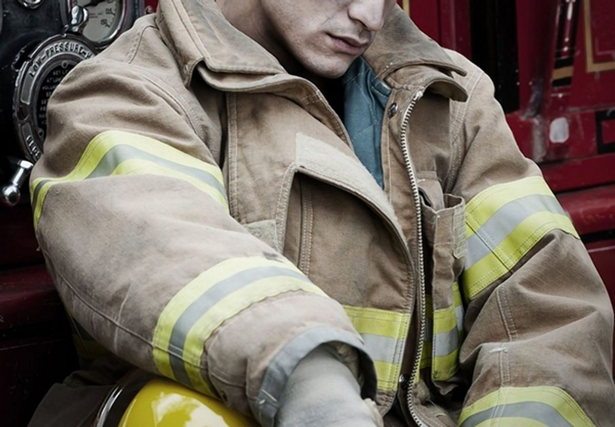 A first responder sitting alone, looking distressed and contemplative, as he grapples with the challenges of substance abuse.