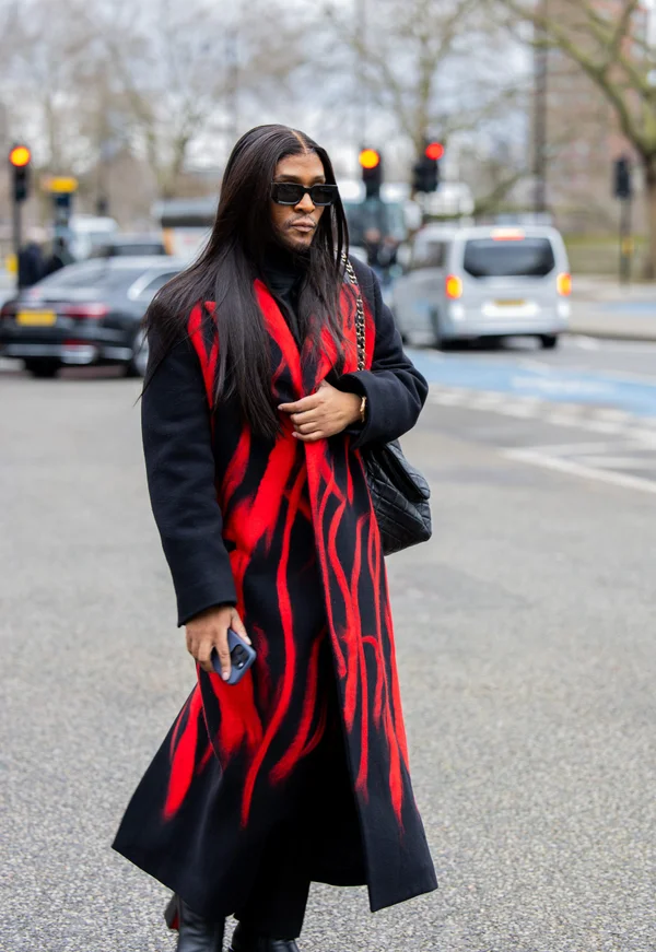 Picture showing a guy dressed in a fiery coats and with shades to match