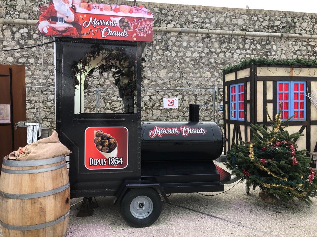 A cart with a christmas tree and a barrel

Description automatically generated