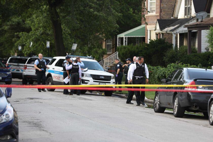 Police investigate the scene where a 25-year-old man was fatally shot July 13, 2021, in the 7000 block of South Normal Avenue. 
