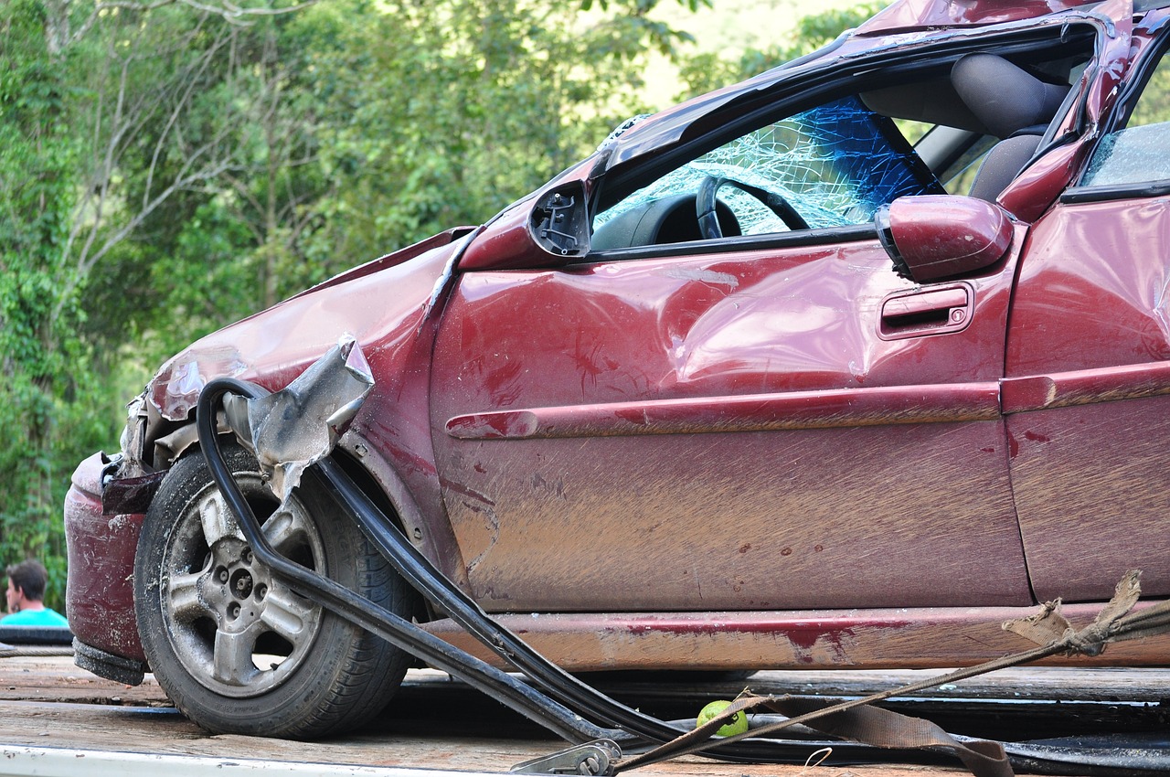 a damaged red car after collision