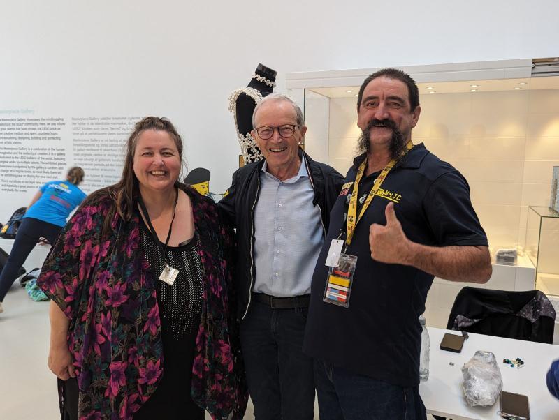 A photo of Veronica Young and her husband with Kjeld Kirk Kristiansen at the LEGO House Masterpiece Gallery