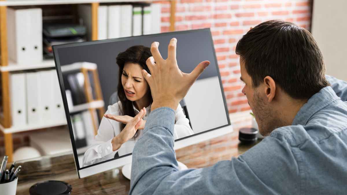 Man looking at a woman in a monitor with his hand up MSN.