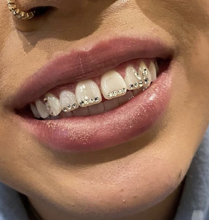 Close up view of a lady rocking a smile while showing off her gorgeous rocks