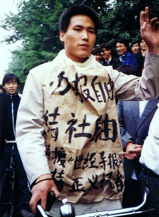 A person wearing a large shirt with writing on itDescription automatically generated
