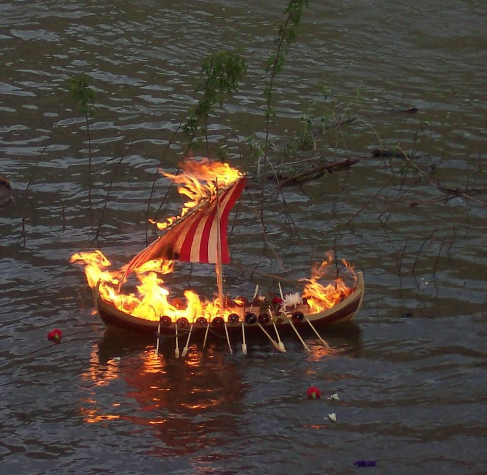 A boat on fire in water

Description automatically generated