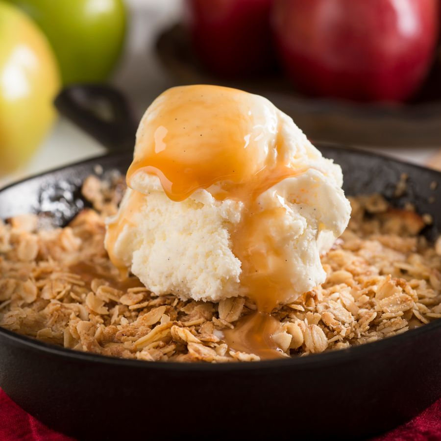 delicious apple crisp with ice cream and caramel on top