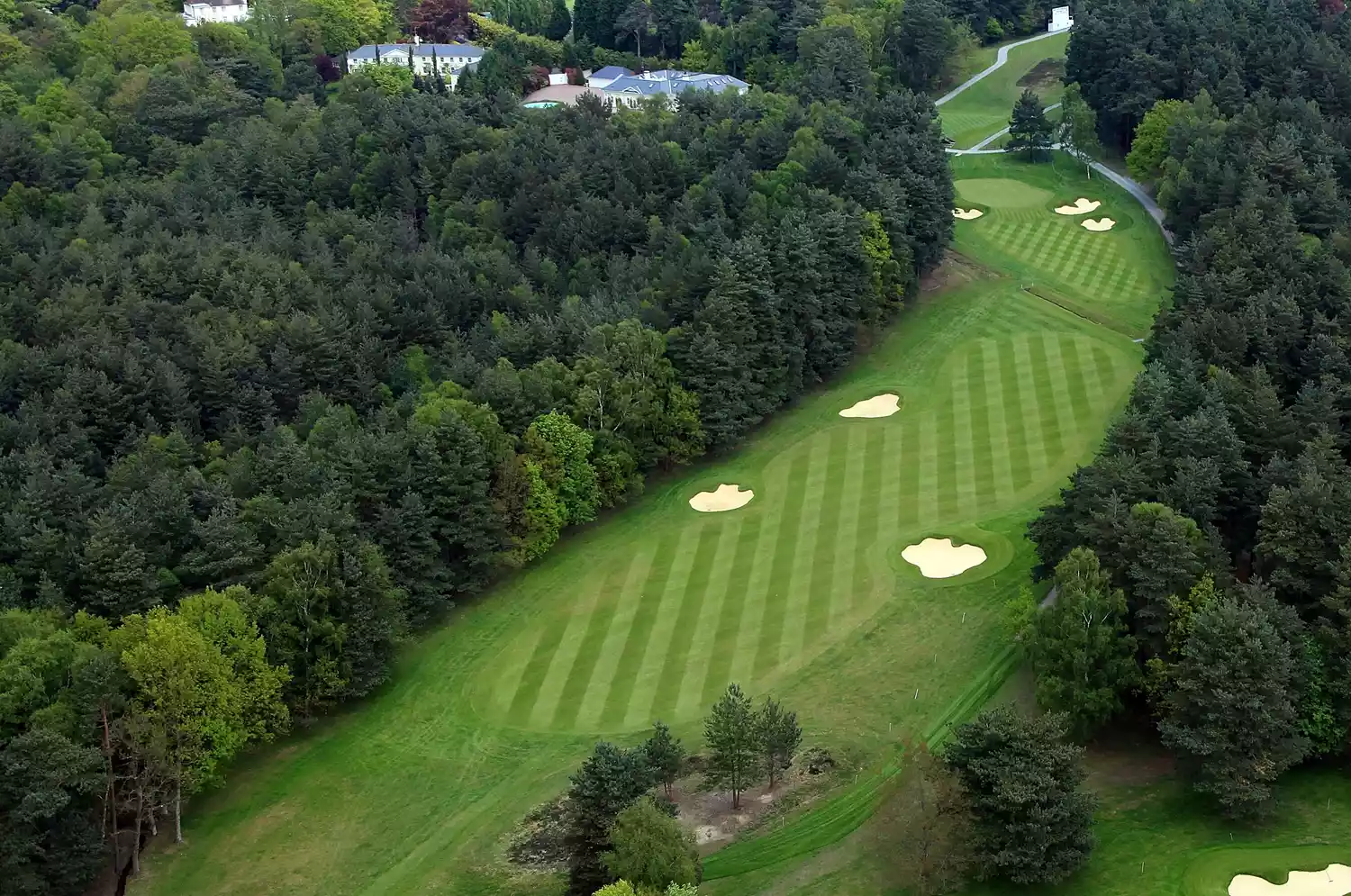 The fairway lies between the tee ground and the green and has a lighter color as it is closely mown.