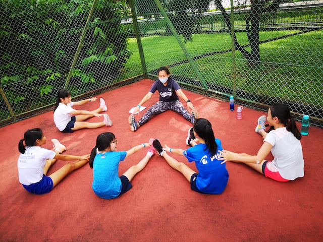 Netball Players Aged 10 to 12 stretching