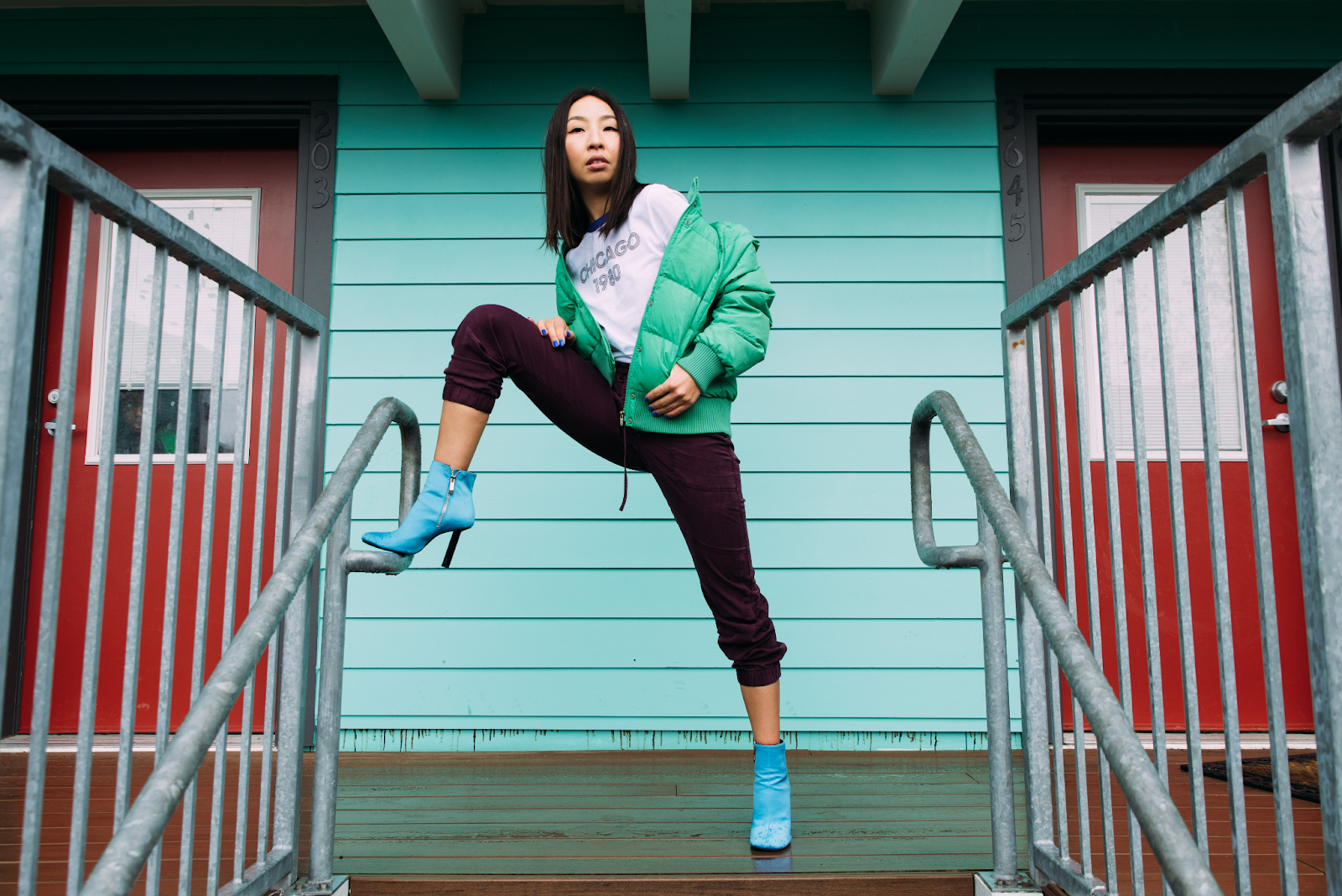 A Girl With an Edgy Pose - With Her Foot on a Staircase Railing