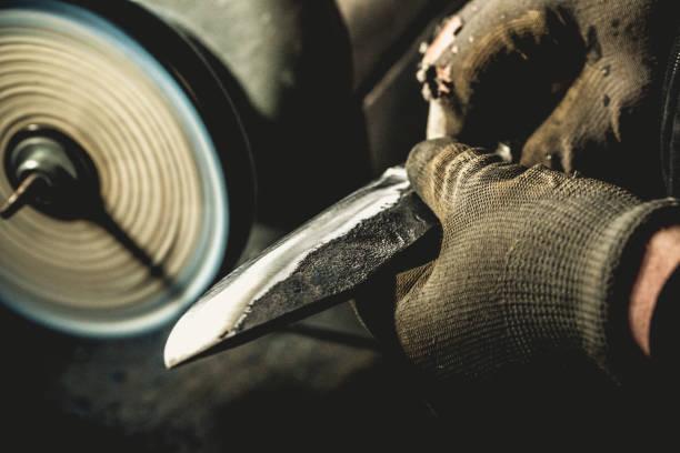 A person holding a knife Description automatically generated