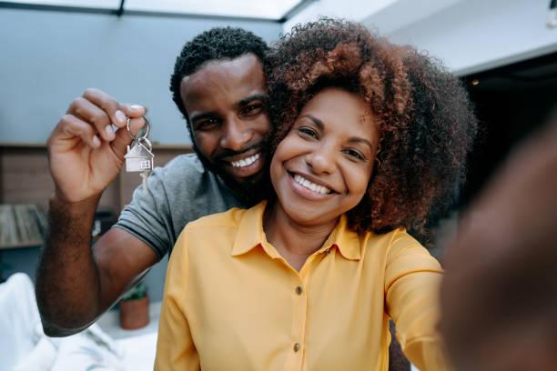 ecstatic couple making selfie in new house - lovers african  stock pictures, royalty-free photos & images