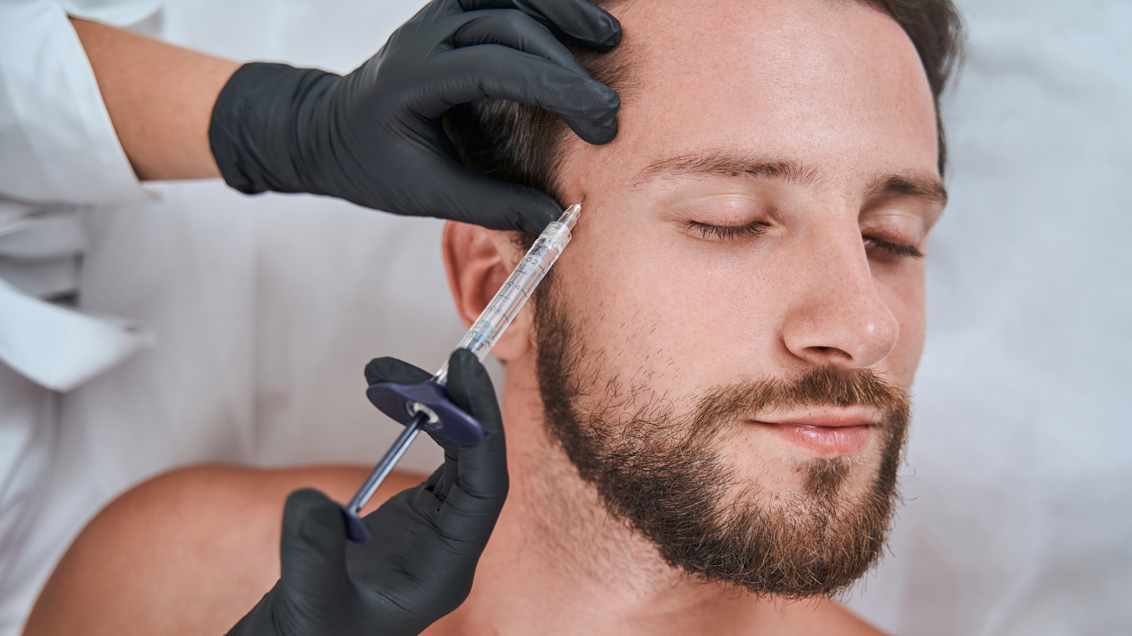 Man getting injected with dermal filler.