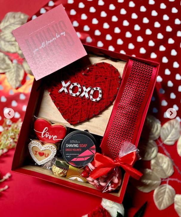A box with a heart and a ribbon

Description automatically generated