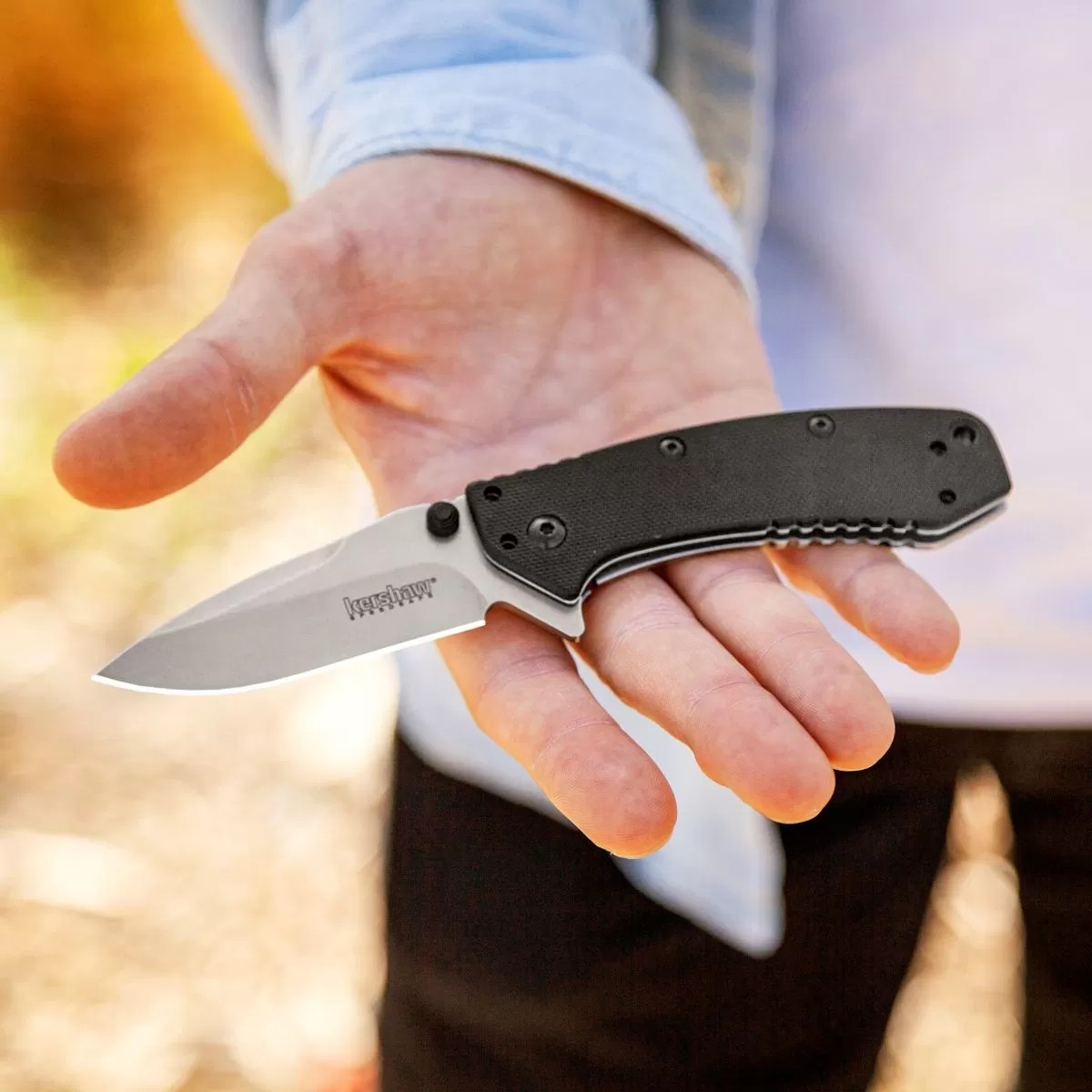 a folding knife in a hand