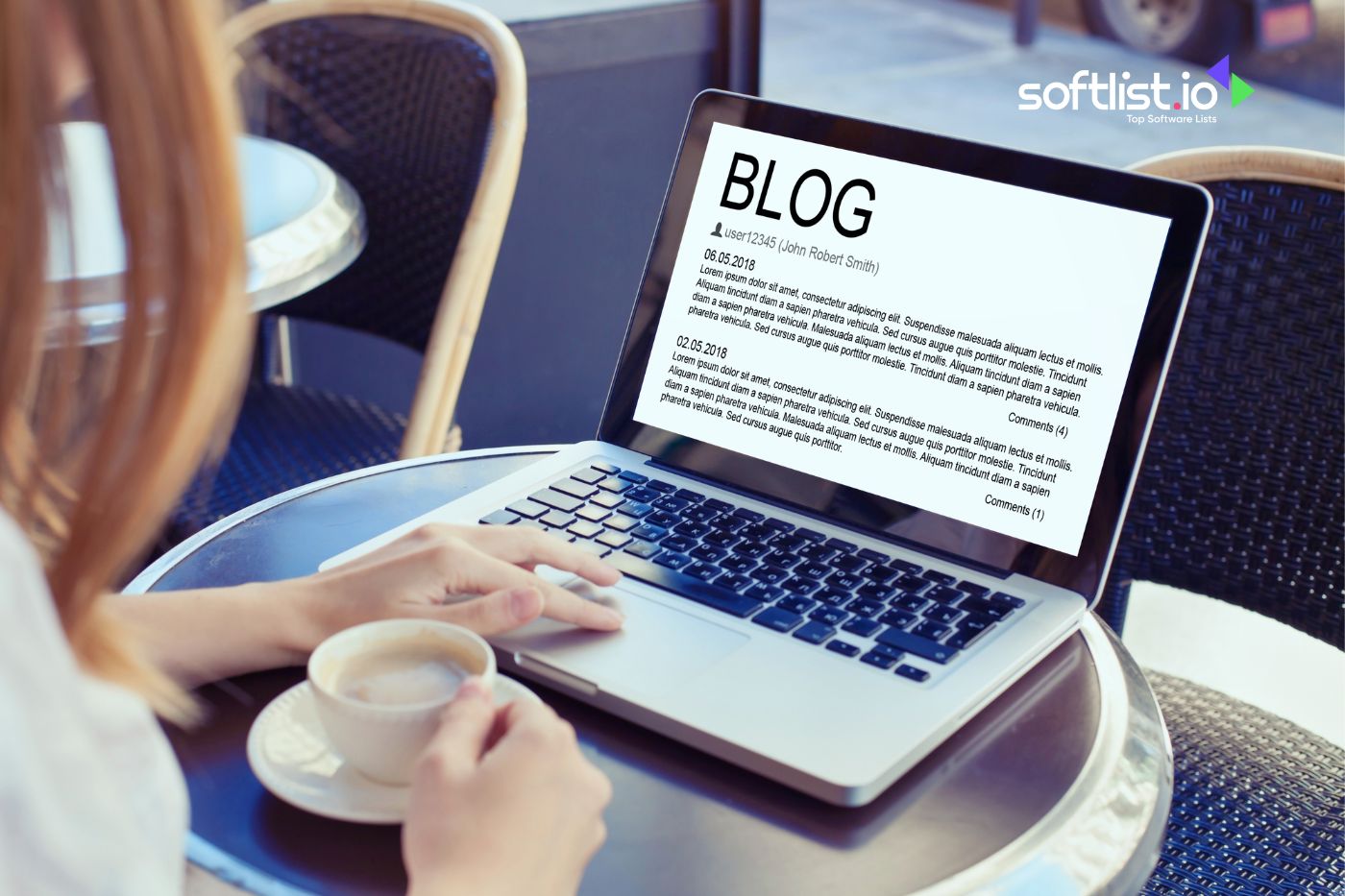 Woman blogging on laptop at outdoor café