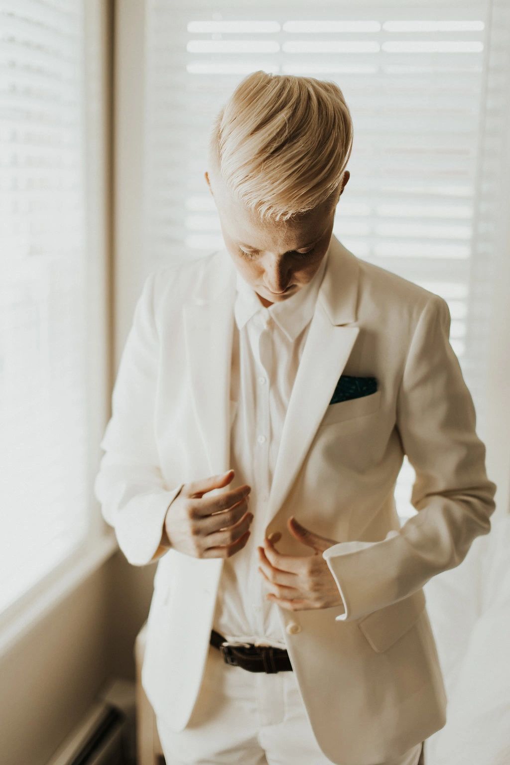 Bride touching suit jacket