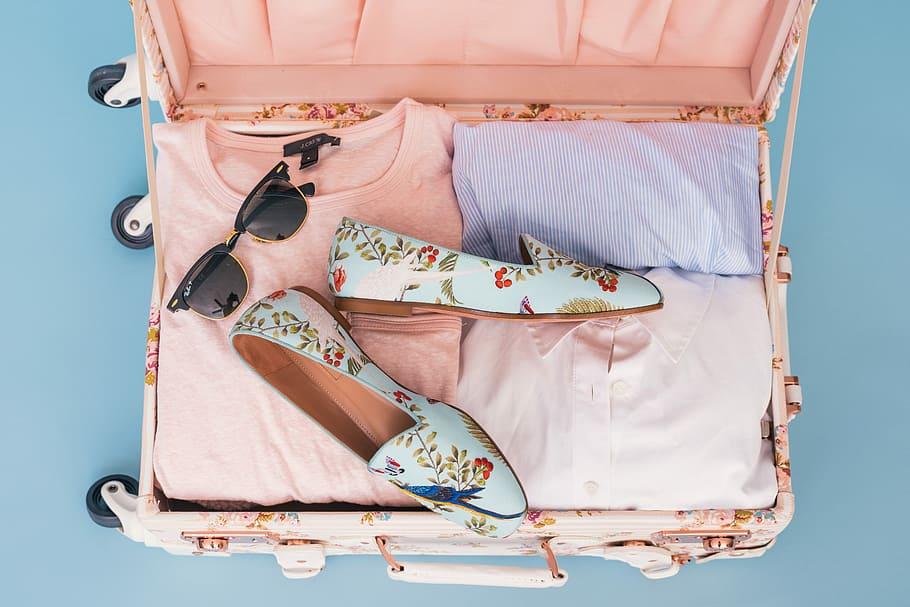 picture shows a suitcase with shoes on top of cloths