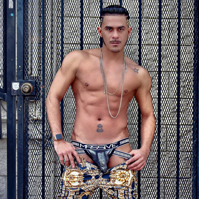 Cesar Xes shirtless pulling down his gold print pants to reveal gay dick print in andrew christian massive jockstrap with faux versace design