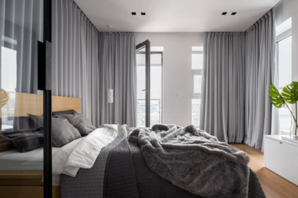 Grey bedroom with light curtains