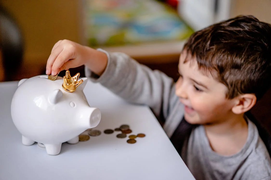 A child playing with the piggy bank