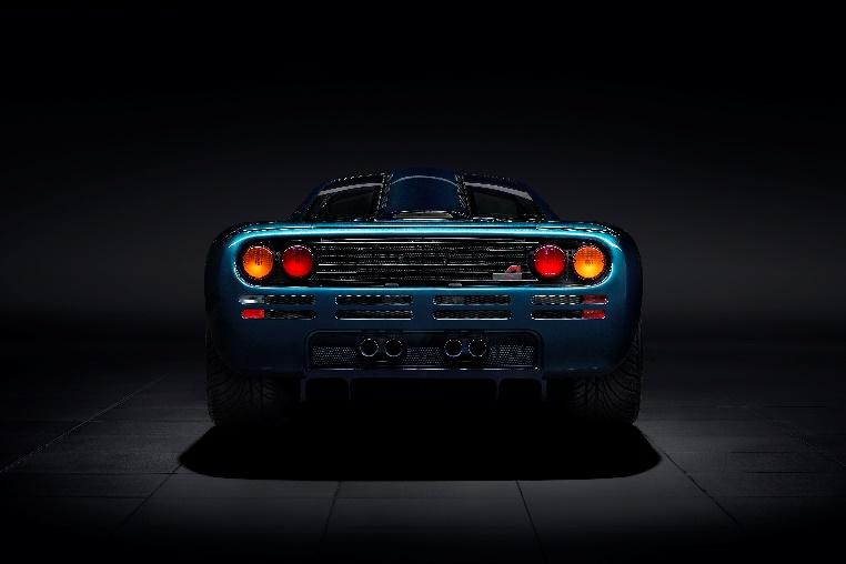 The back of a blue sports car

Description automatically generated