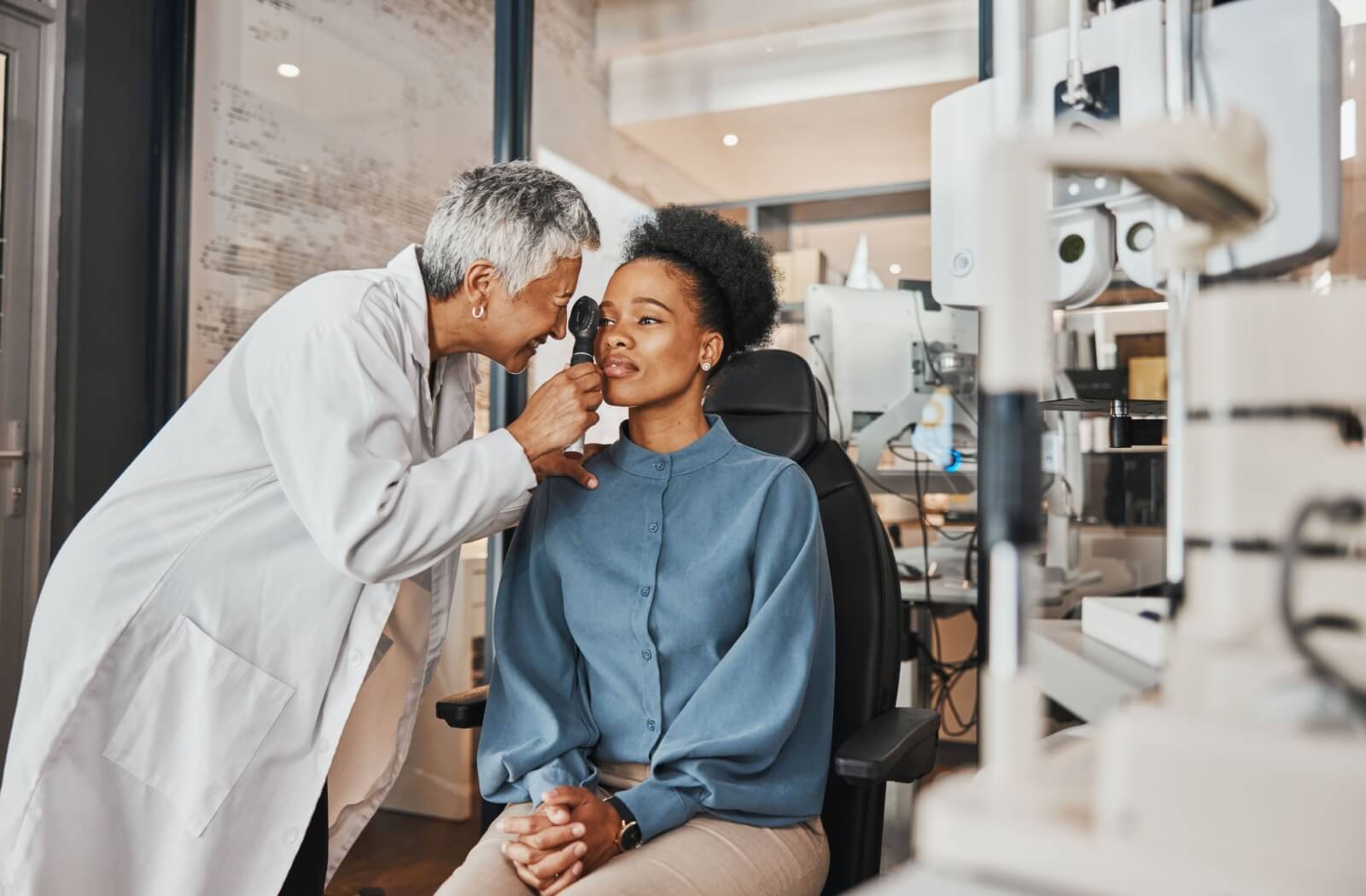 A woman getting her eyes checked by an eye doctor.