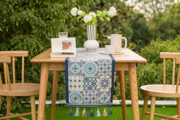 Large patterned blue table runner with intricate geometric and floral prints, and tassels