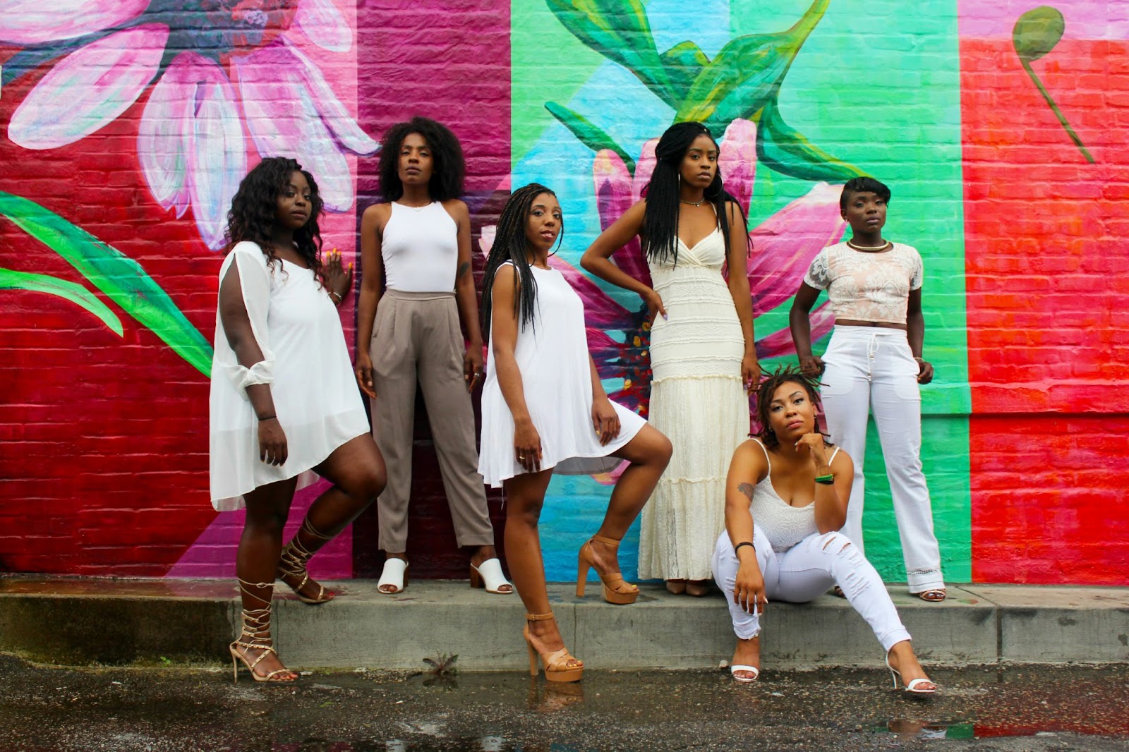 A group of women posing for a pictorial while wearing the best SS24 fashion trends.