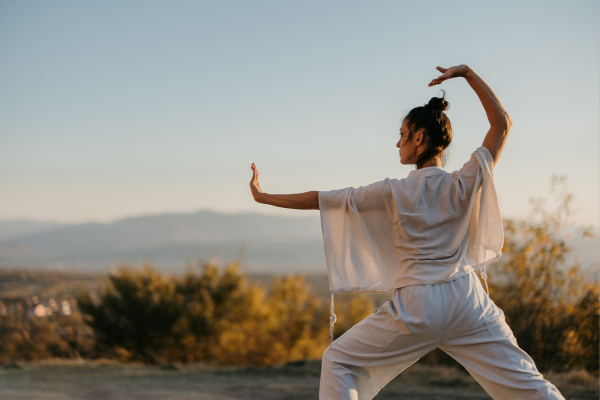 Young women performing yoga to balance chakra and improve physicall well-being.