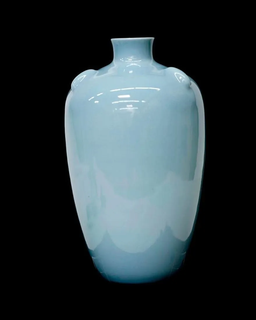 A blue vase on a black backgroundDescription automatically generated