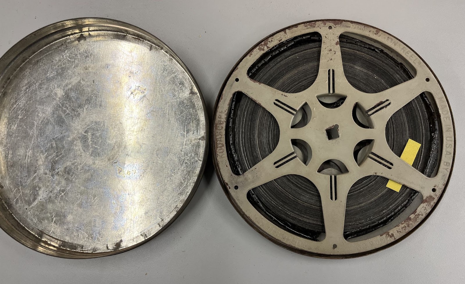 Metal can holding film reel with yellow test strip tucked in