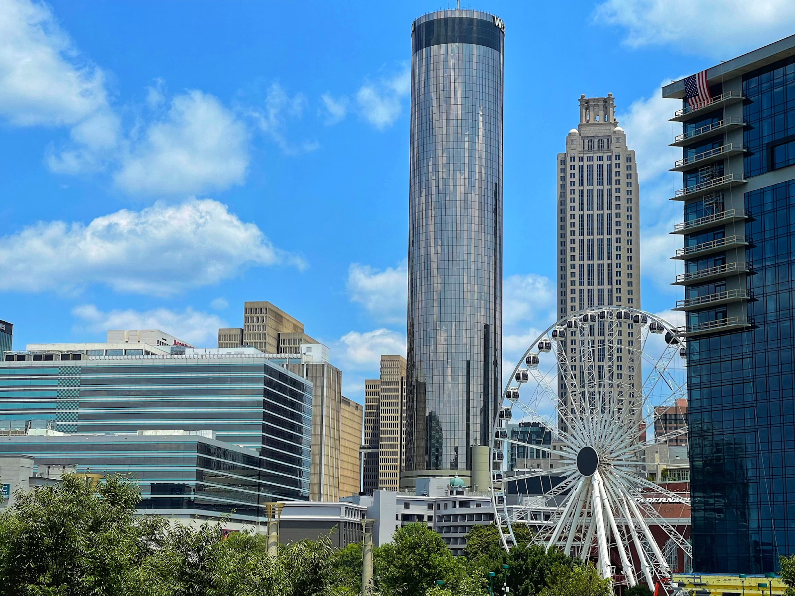 Atlanta cityscape featuring a Ferris wheel adjacent to tall buildings.