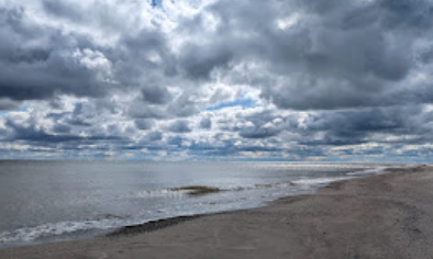 Image of a beach with dramatic clouds.