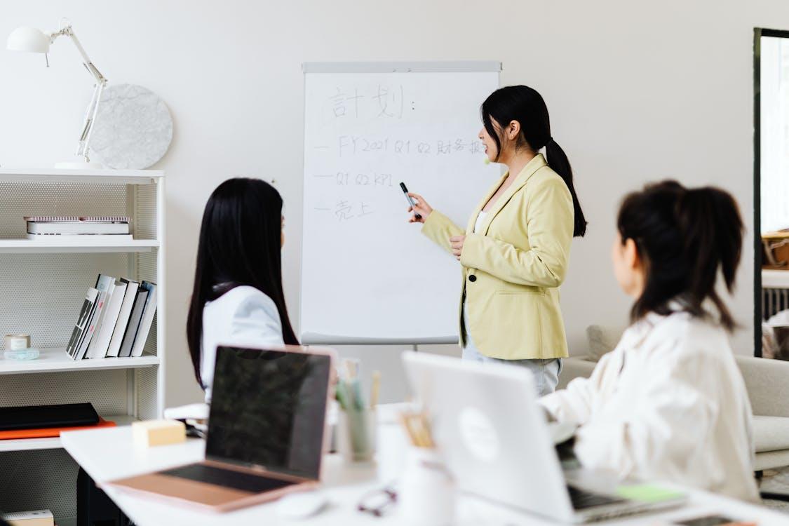 Free Woman Presenting to Her Coworkers Stock Photo