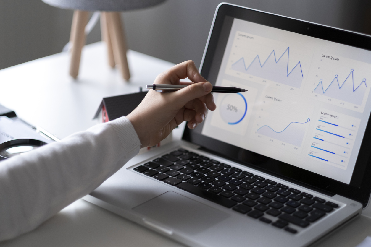 A laptop displaying graphs indicating analytics of SEO services.