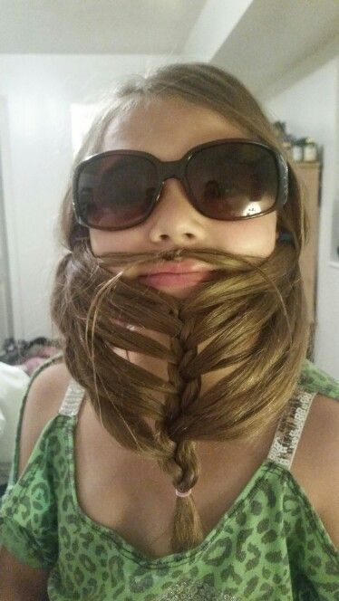 Picture of a girl using her hair  to make a beard for the event