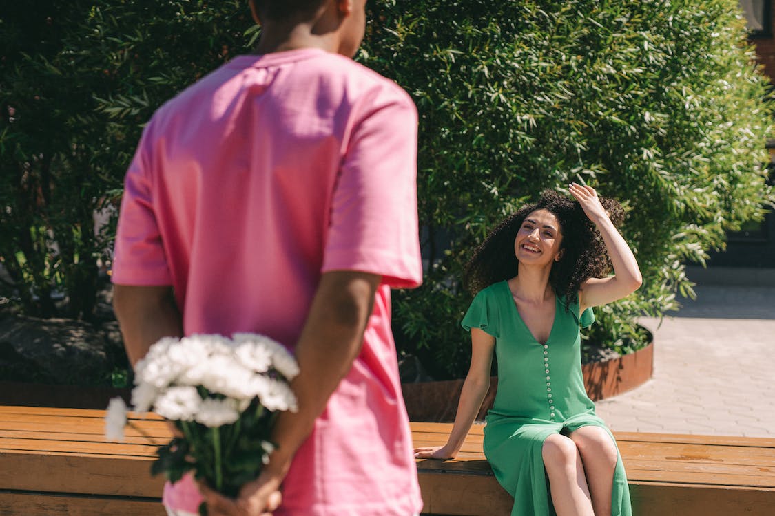 A man surprising his lady with  flowers