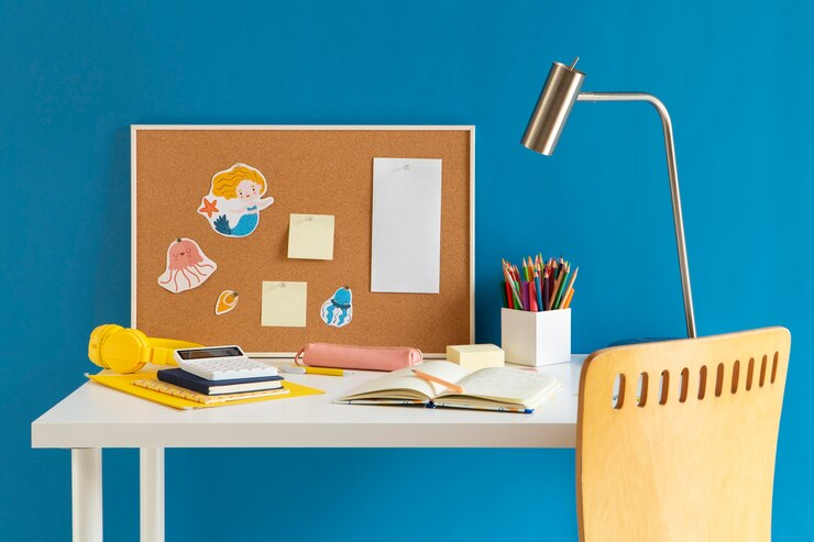 Child's desk with lamp and notebook for home learning.