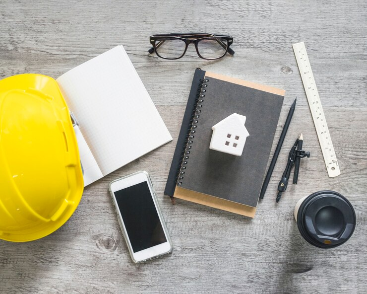 Hardhat, stationery, and smartphone, tools for engineering success.