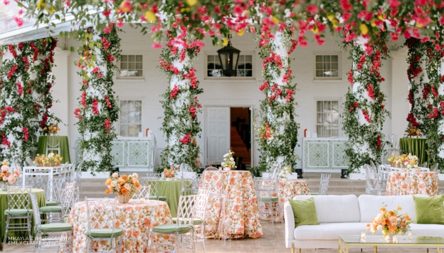 Beautifully set tables with pops of spring table cloths and flowers wrapped around white columns 