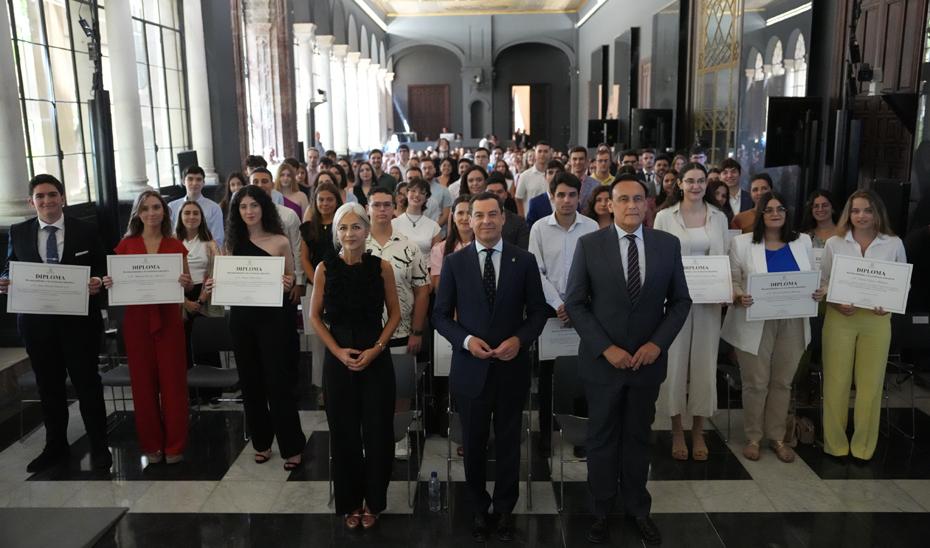El presidente de la Junta, Juanma Moreno, posa junto con los jóvenes andaluces reconocidos con  los mejores expedientes de Bachillerato, Enseñanza Artísticas Superiores y Formación Profesional de Andalucía.