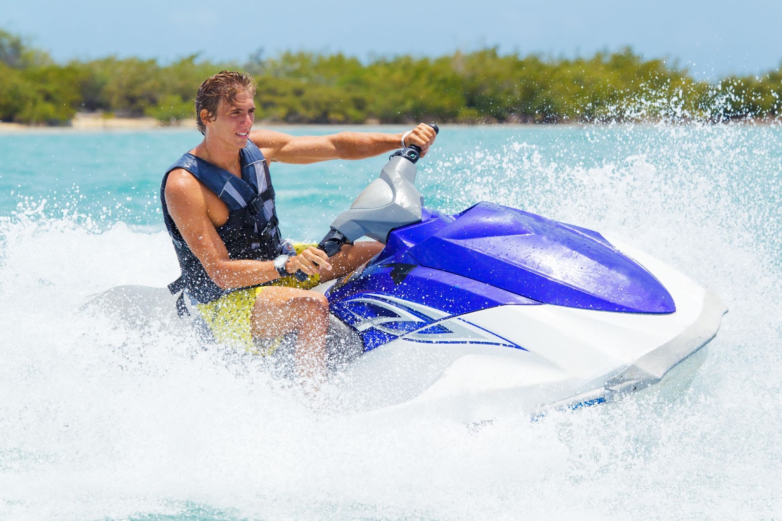 A man is riding in a jet ski.
