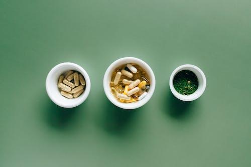 Free White Ceramic Bowls with Supplements Stock Photo